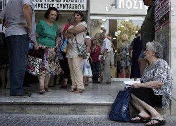 Pensioners wait outside Greece's largest Social Security Organisation (IKA) in Athens, Friday, May 31, 2013. Hundreds of retirees waited in line for hours outside IKA offices Friday, after missing a deadline to renew their pension registration as part of an effort in the bailed out country to combat benefit fraud. (AP Photo/Petros Giannakouris)