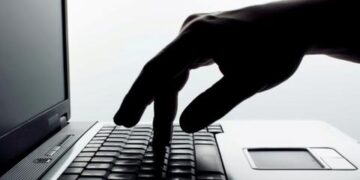 finger pressing keyboard