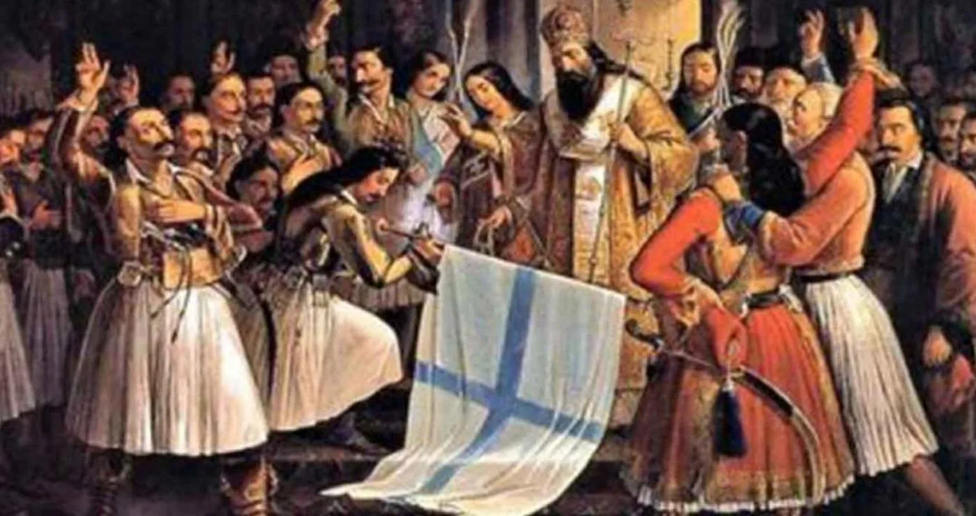 Μια σκηνή από τον εορτασμό της 25ης Μαρτίου 1821, με έναν ιερέα να ευλογεί την ελληνική σημαία ενώ πλήθος ανθρώπων πανηγυρίζει.